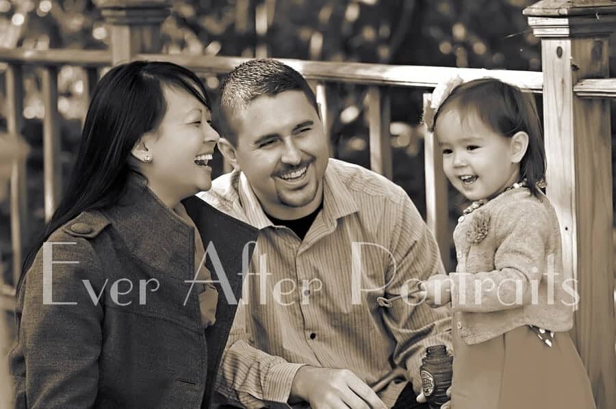 Parents enjoying the autumn colors with their two year old.