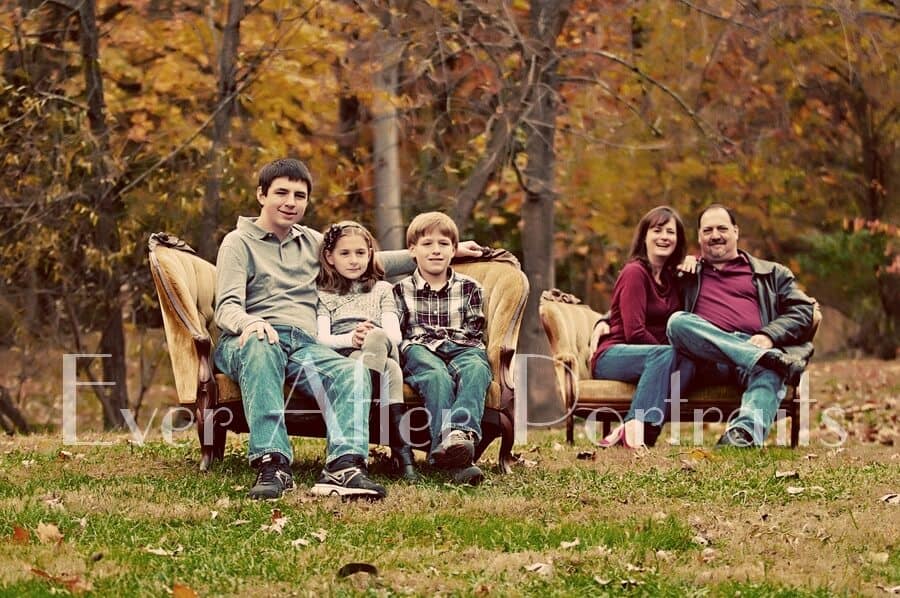 Family of five in outdoor sofa portrait.