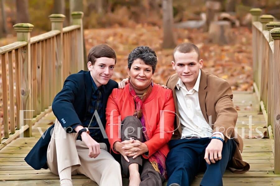 Mother with grown sons in outdoor image.